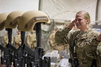 Service members from several units at Bagram Air Field, Afghanistan, pay their respects during a fallen comrade ceremony held in honor of six Airmen Dec. 23, 2015.