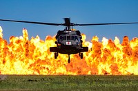 A UH-60 Black Hawk helicopters hovers while a wall of fire burns during the South Carolina National Guard Air and Ground Expo combined arms demonstration at McEntire Joint National Guard Base, South Carolina, May 7, 2017.