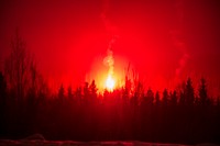 A flare illuminates a distant wood-line as Soldiers assigned to 1st Battalion, 5th Infantry Regiment, 1st Stryker Brigade Combat Team, 25th Infantry Division, U.S. Army Alaska, conduct a night assault during Operation Punchbowl at Joint Base Elmendorf-Richardson, Alaska, Feb. 10, 2018. Operation Punchbowl was a battalion-level, combined arms, live-fire exercise that focused on arctic lethality. During the operation three 150-Soldier companies maneuvered through varied terrain; attacking and seizing enemy positions as well as eliminating key weapons and vehicles being utilized by the enemy. (U.S. Air Force photo by Alejandro Peña). Original public domain image from Flickr