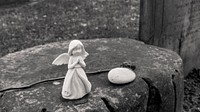 Little angel sculture on a rock. Original public domain image from Flickr