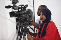 A journalist films a press briefing addressed by the Special Representative of the Chairperson of the African Union Commission (SRCC) for Somalia, Ambassador Francisco Madeira on AMISOM&#39;s latest activities and achievements in Mogadishu on April 26, 2018. Original public domain image from <a href="https://www.flickr.com/photos/au_unistphotostream/40812851435/" target="_blank">Flickr</a>