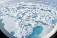 ARCTIC OCEAN - A multi-year ice floe slides down the starboard side of the Coast Guard Cutter Healy Aug. 12, 2009, as the ship heads north into even thicker ice. "You can tell that this is a multi-year ice floe by the light blue melt ponds that have formed on top of the floe," said Pablo Clemente-Colón, chief scientist at the U.S. National Ice Center.Photo Credit: Patrick Kelley, U.S. Coast Guard. Original public domain image from Flickr