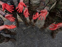 Civilian actors dressed in moulage to simulate an injury stands by to be placed at an accident site during a full scale exercise. Original public domain image from Flickr