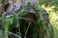 Arctic Aurora 2019A sniper from the 1st Airborne Brigade Japanese Ground Self-Defense Force avoids detection while leaving the battlefield during training with U.S. Army Alaska’s 4th Infantry Brigade Combat Team (Airborne), 25th Infantry Division at Joint Base Elmendorf-Richardson, Alaska, as part of exercise Arctic Aurora, June 5, 2019. Arctic Aurora is a yearly bilateral training exercise involving elements of U.S. Army Alaska and the JGSDF, which focuses on strengthening ties between the two by executing combined small unit airborne proficiency operations and basic small arms marksmanship with a focus on combat readiness and interoperability between the two military forces. (U.S. Air Force photo by Alejandro Peña). Original public domain image from Flickr