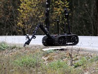 Talon robot inspecting an area for a suspected Improvised Explosive Device. Original public domain image from Flickr
