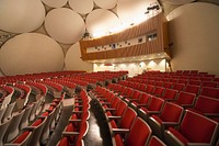 Auditorium equipped with the latest in multi-media equipment, including side and rear lighting that accommodates color television cameras and motion picture filming. The large plaster disks on the inside surface of the dome enhance the acoustics of the auditorium. The Bubble is home to special events, prominent speakers, and large conferences. Original public domain image from Flickr