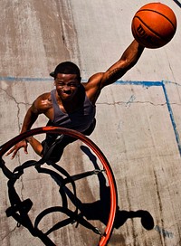 U.S. Air Force Senior Airman Nathaniel Mills, 99th Security Forces Squadron patrolman, dunks a basketball Sept. 18, 2013, at a basketball court in Las Vegas.