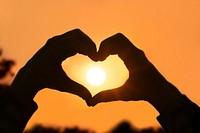 Heart hands frame the sun, free public domain CC0 photo.