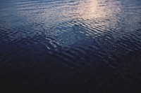 Calm waters in dark blue ocean background