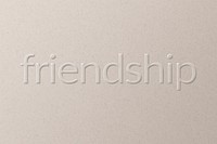 Friendship embossed text on white paper background