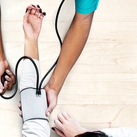 Nurse measuring patient blood pressure