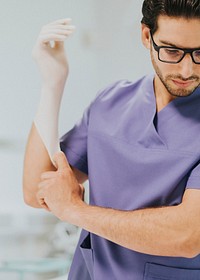 Male nurse putting on a glove