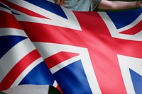Person holding a British flag background, national symbol