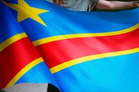 Person holding Congo flag background, national symbol