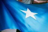 Person holding Somalia flag background, national symbol