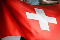 Person holding Switzerland flag background, national symbol