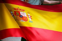 Person holding Spanish flag background, national symbol