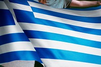 Person holding Greek flag background, national symbol