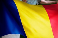 Person holding Chad flag background, national symbol