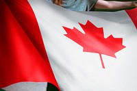 Person holding Canadian flag background, national symbol