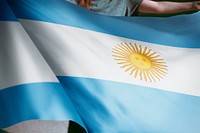 Person holding Argentina flag background, national symbol