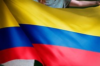 Person holding Colombian flag background, national symbol