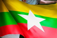 Person holding Myanmar flag background, national symbol