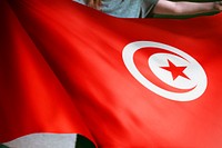 Person holding Tunisia flag background, national symbol