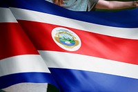 Person holding Costa Rica flag background, national symbol