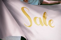 Person holding pink sale flag background