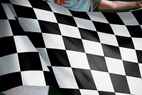 Person holding checkered racing flag background