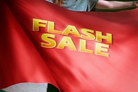 Person holding red flash sale flag background