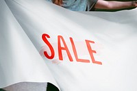 Person holding white sale flag