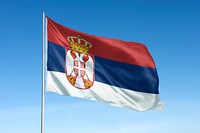 Waving Serbia flag, national symbol, blue sky