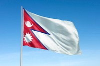 Waving Nepal flag, national symbol, blue sky
