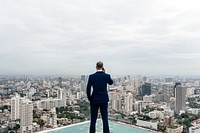 Business man talking on a phone with a cityscape background