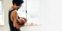 Happy Asian dad holding his baby in his arms blank space 