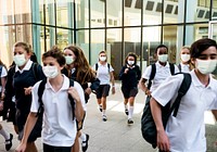 High school students wearing masks on their way home