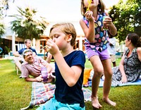 Kids enjoying blowing bubble outdoors