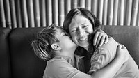 Young boy hugging and kissing his mom