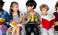 Group of students is sitting and reading a book.