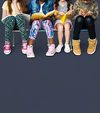 Diverse group of kids sitting in a row reading books