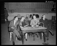 Jack Schaindlin, musical director, Eleanor Herring, Philip Martin, Jr., technical director, Max Brasch, film editor,  at the Long Island Studios of the Army Signal Corps for the recording of Spencer Tracy's narration of the "Ring of Steel," an Office of Emergency Management (OEM) film, on February 19th, 1942. Sourced from the Library of Congress.
