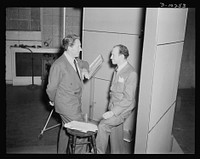 Spencer Tracy, narrator and Garson Kanin, director, at the Long Island Studios of the Army Signal Corps for the recording of Spencer Tracy's narration of the "Ring of Steel," an Office of Emergency Management (OEM) film, on February 19th, 1942. Sourced from the Library of Congress.