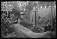 Glen Echo, Maryland. A small girl enjoying a ride on the merry-go-round at Glen Echo Park. Sourced from the Library of Congress.