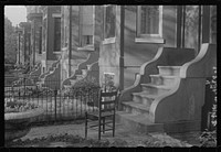 Washington, D.C. A row of houses, all alike, showing seven entrances and a bit of yard in front of each, in one of the nicer old sections of the city. Sourced from the Library of Congress.