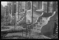 [Untitled photo, possibly related to: Washington, D.C. A row of houses, all alike, showing seven entrances and a bit of yard in front of each, in one of the nicer old sections of the city]. Sourced from the Library of Congress.