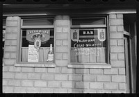 [Window with signs, Mount Carmel, Pennsylvania]. Sourced from the Library of Congress.