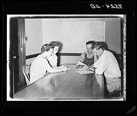Jack Cowan, Farm Security Administration representative, Helen Warren, home supervisor, and Mr. and Mrs. Clarence Thornton, going over farm and home plans. Story County, Iowa. Sourced from the Library of Congress.