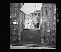 Proprietor in general store in his post office section. Lincoln, Vermont. Sourced from the Library of Congress.